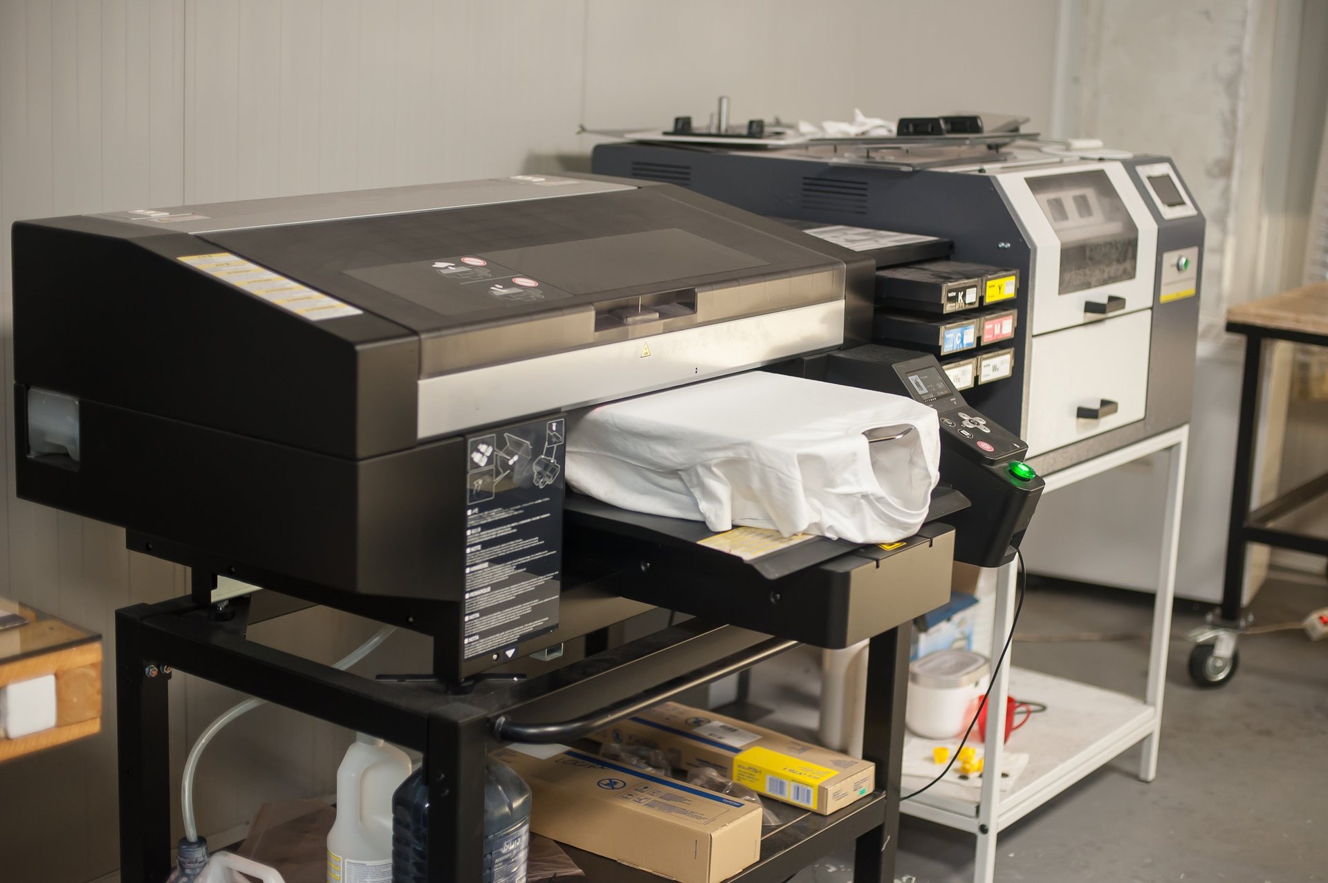 Digital t-shirt printing heat press machine in printing production shop. No people. Nobady