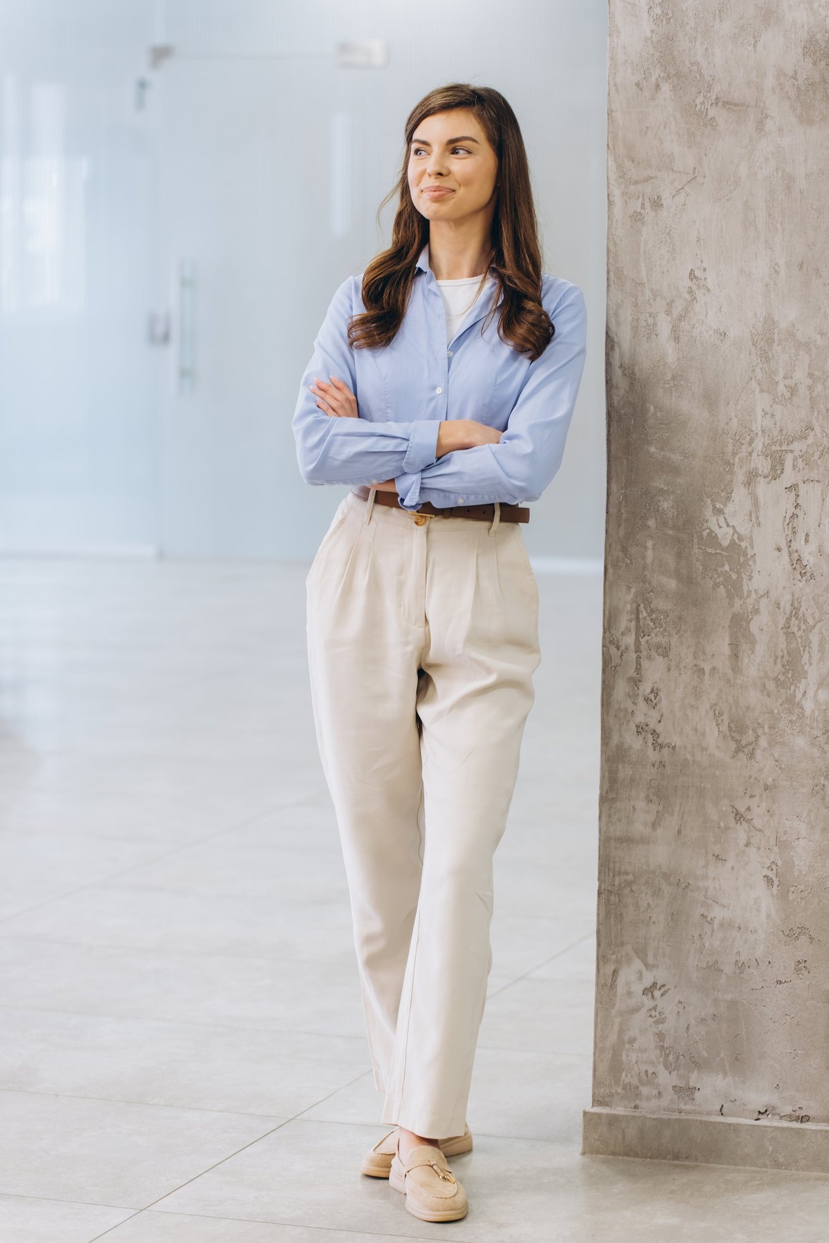 Professional woman standing confidently, ready to help with your custom clothing order