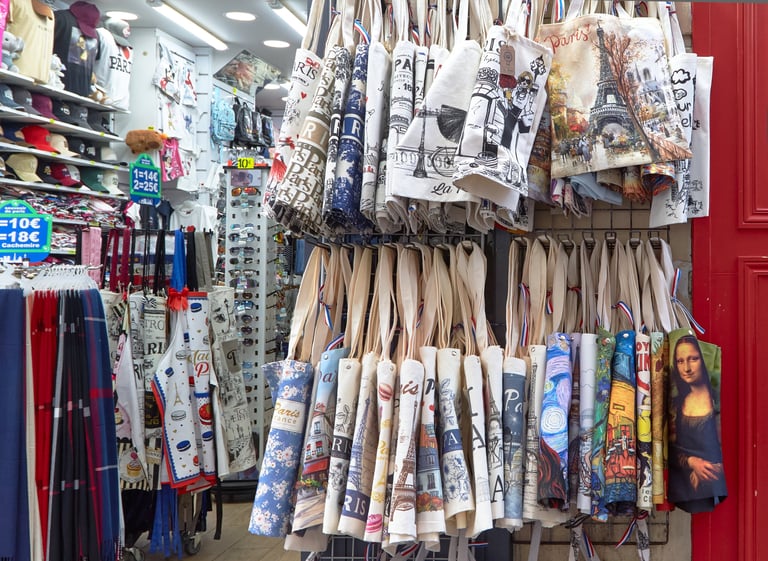 Colorful printed canvas bags hanging in a retail shop display
