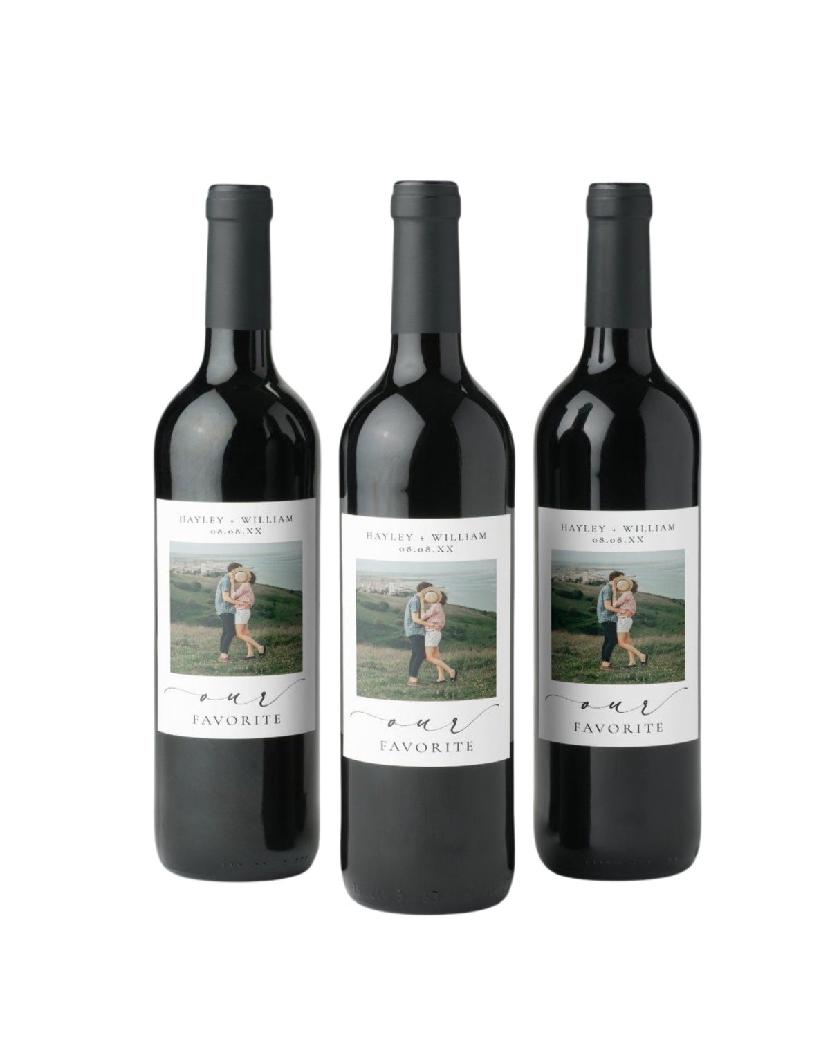 Three custom wine bottles with personalized labels featuring a couple photo and Our Favorite text