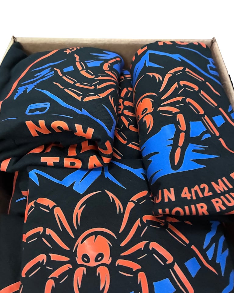 Black graphic t-shirts with orange and blue spider designs