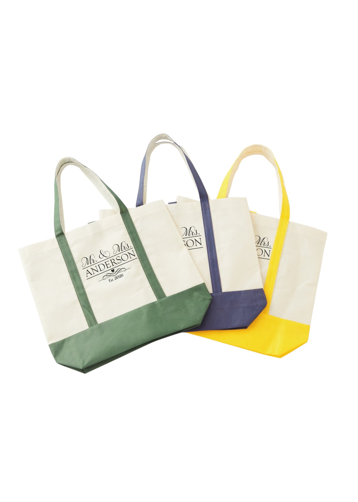 Three canvas tote bags in green, navy blue, and yellow with beige tops and handles, featuring a logo on the front