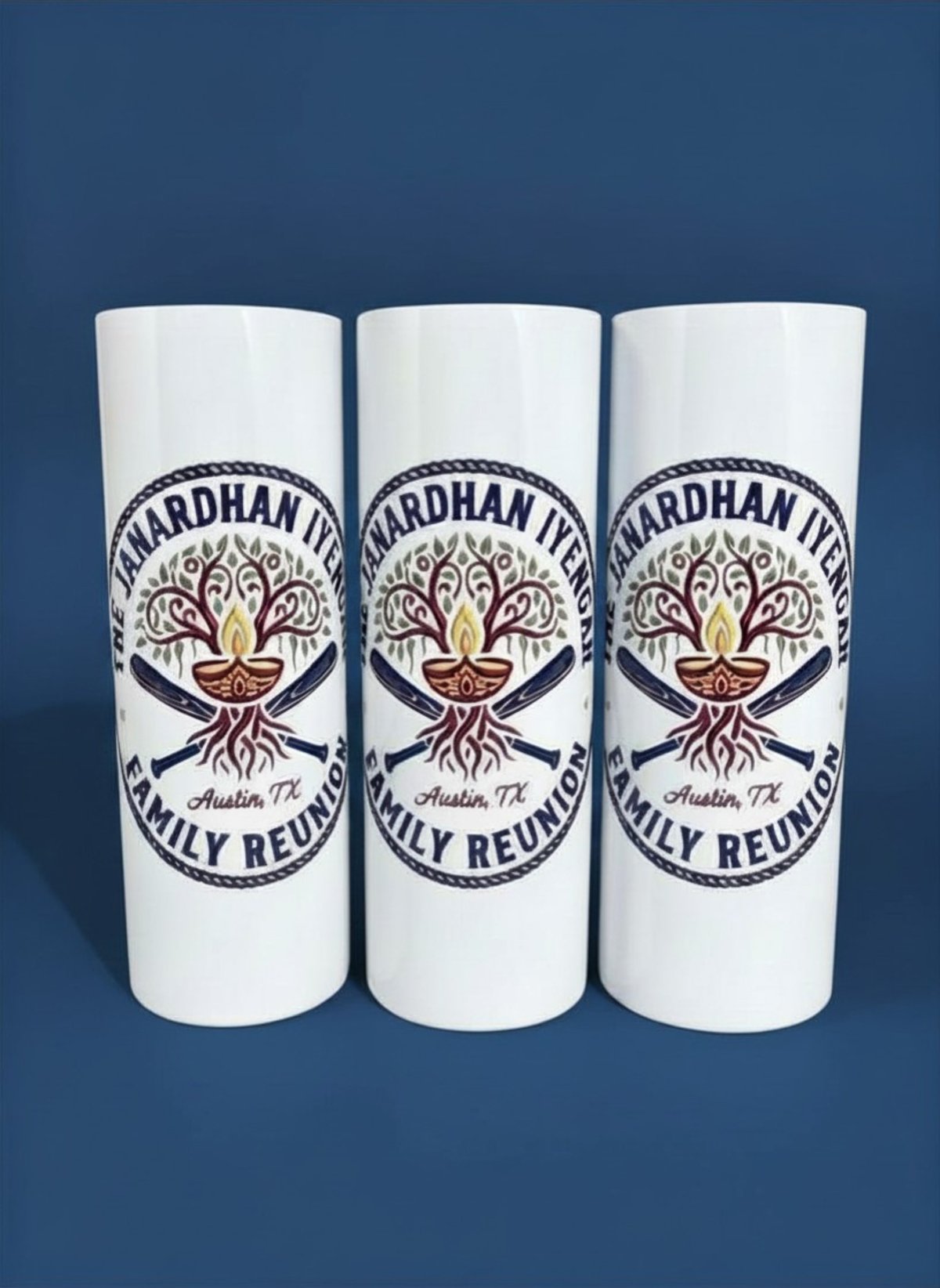 Three white cylindrical cups with Nardhan IV Family Reunion tree logo design on blue background