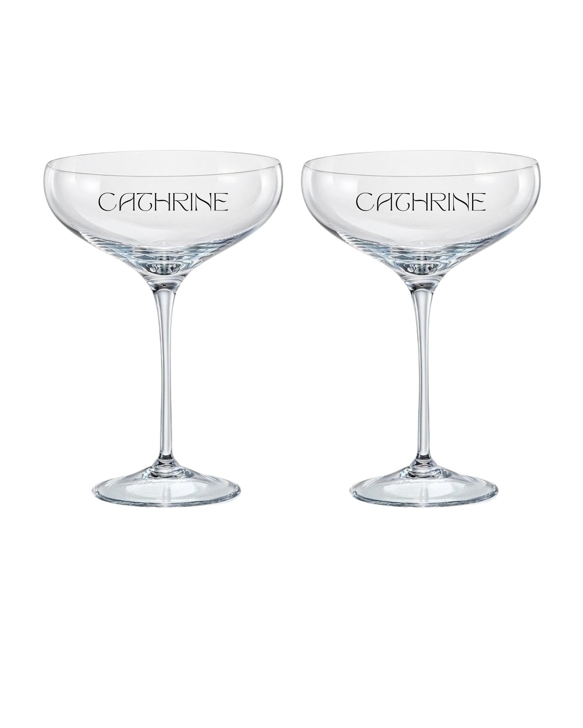 Pair of crystal coupe glasses etched with Caghrine branding, displaying elegant cocktail glassware