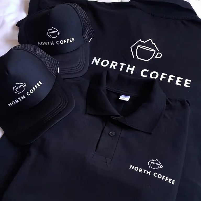 North Coffee branded merchandise including cap, tote bag, and polo shirt