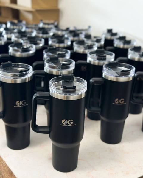 Collection of black insulated travel mugs with 4G logo and handle displayed in rows