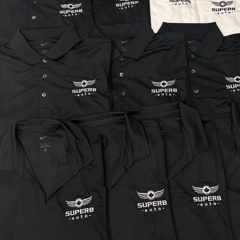Collection of black and white polo shirts and t-shirts with Superb Auto winged logo emblem