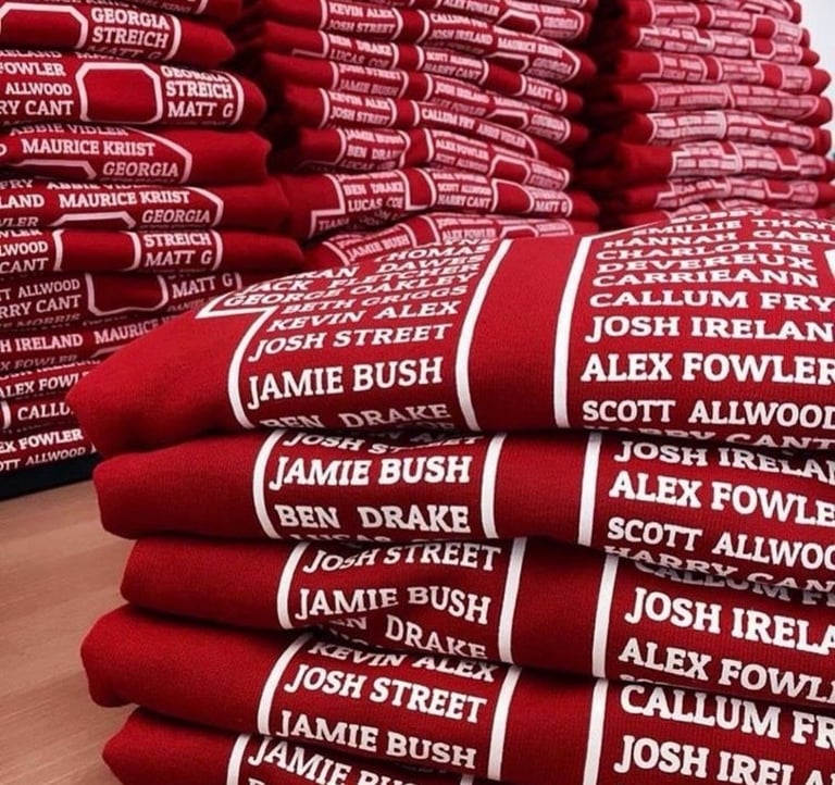 Stacked red Georgia Bulldogs football towels with player names printed in white text